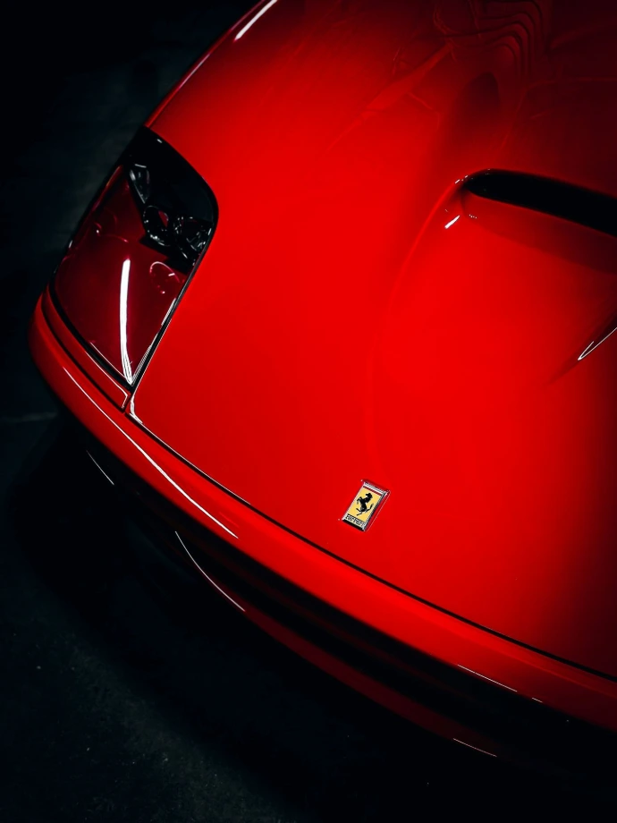 a close up of the hood of a red sports car